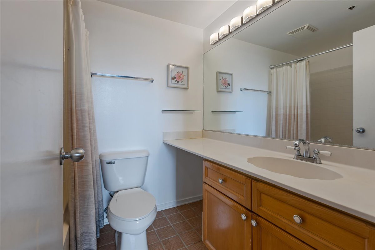 1632 South Indiana Avenue, Unit 403 Chicago, IL 60616 - Photo 15 of 23 a bathroom with a granite countertop toilet sink and mirror