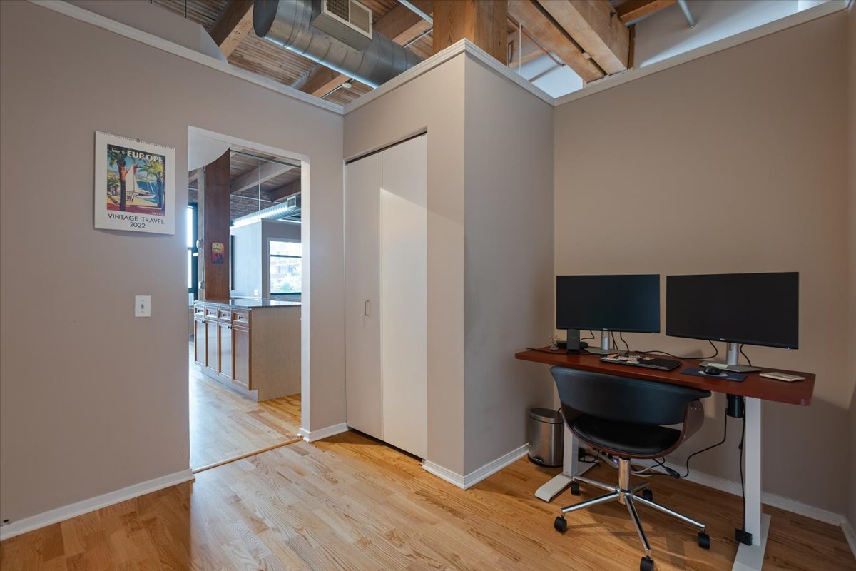 1632 South Indiana Avenue, Unit 403 Chicago, IL 60616 - Photo 17 of 23 a view of a workspace with furniture and wooden floor