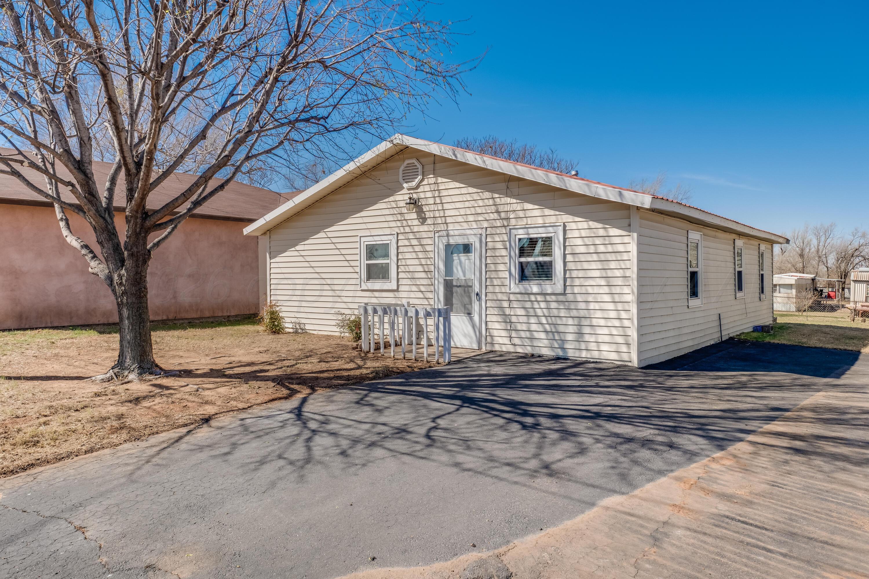 106 South Canadian Street Wheeler, TX 79096 - Photo 1 of 20 a view of a house with a backyard