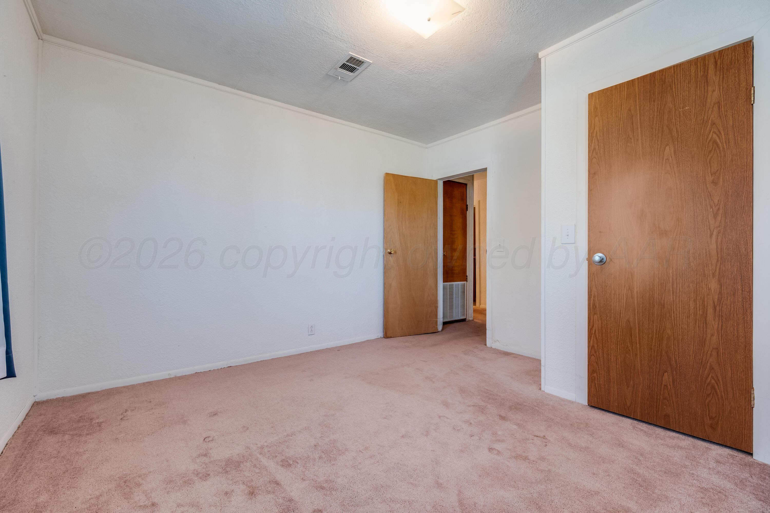 106 South Canadian Street Wheeler, TX 79096 - Photo 12 of 20 an empty room with closet and a bathroom