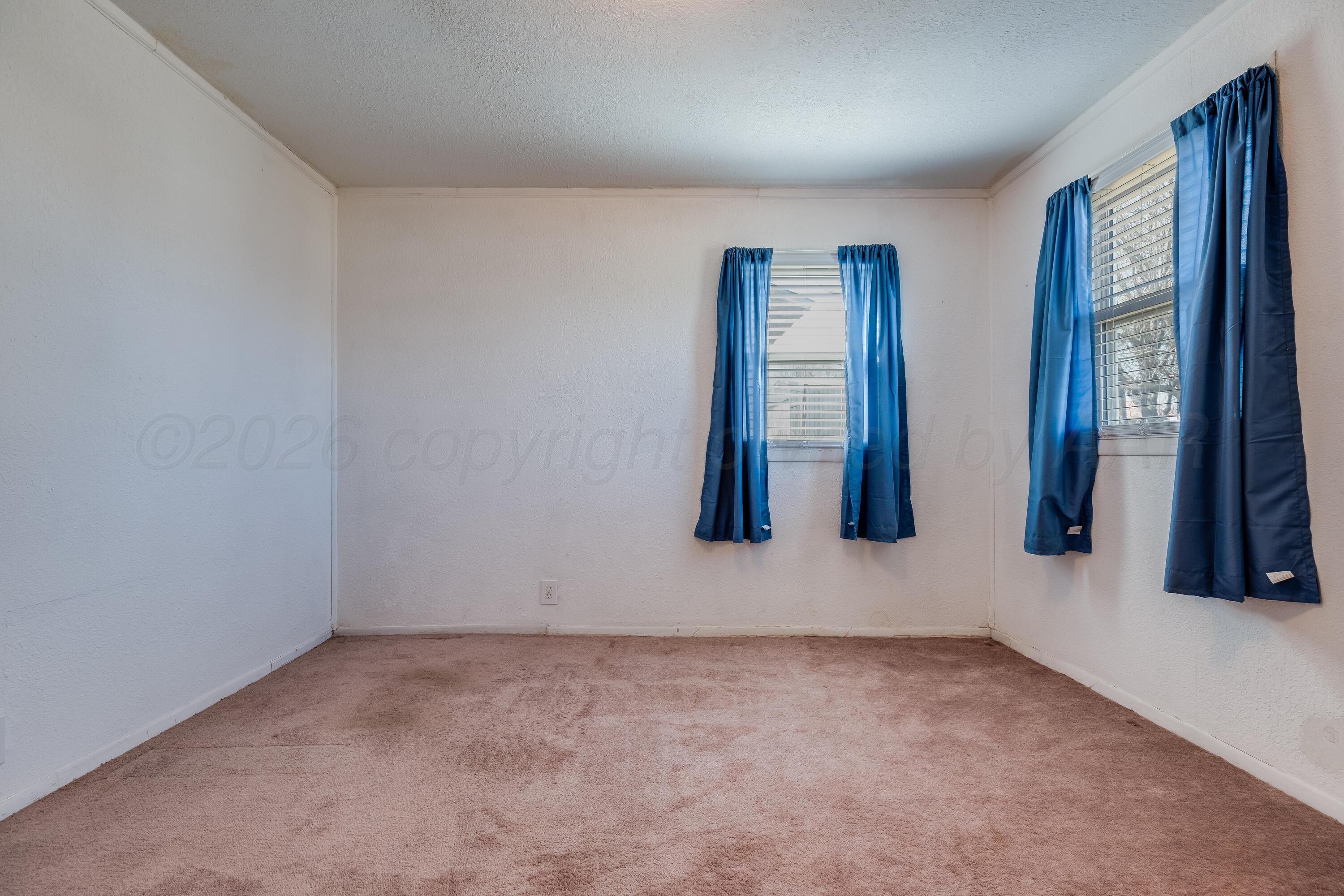 106 South Canadian Street Wheeler, TX 79096 - Photo 14 of 20 an empty room with windows