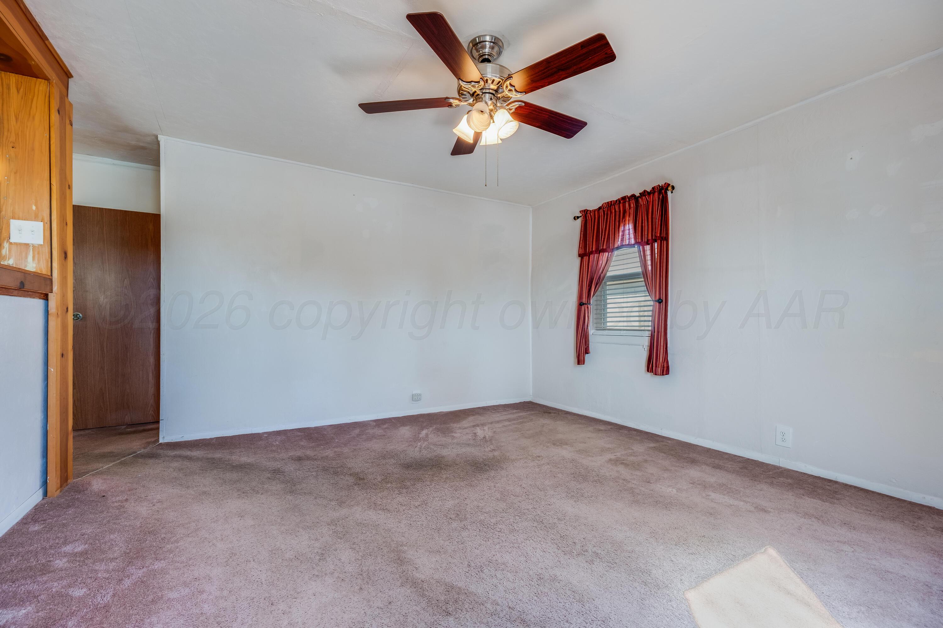 106 South Canadian Street Wheeler, TX 79096 - Photo 4 of 20 an empty room with closet and fan