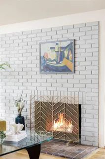 a view of a porch with a table and chairs and floor to ceiling window and wooden fence