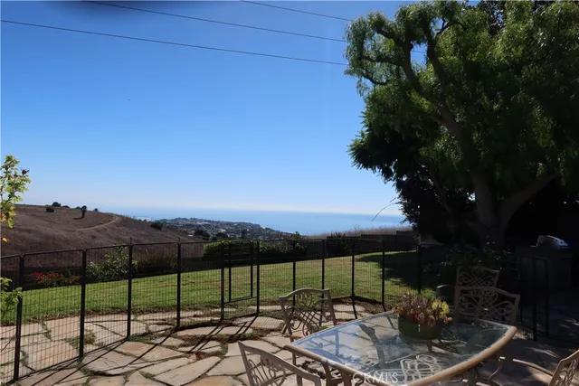 a view of a house with a small yard and potted plants