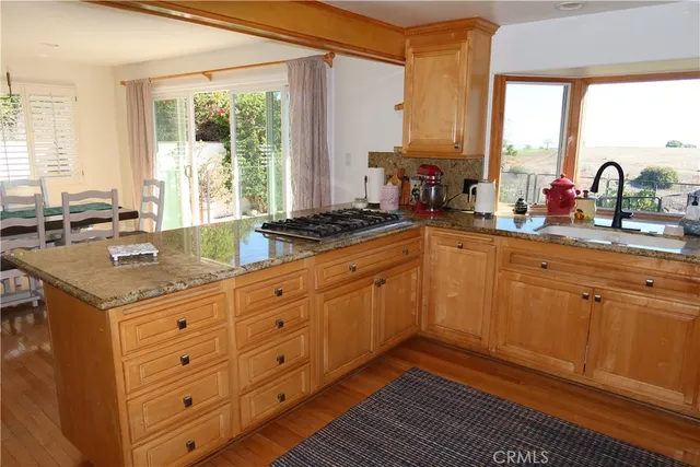 a kitchen with granite countertop a sink and a window
