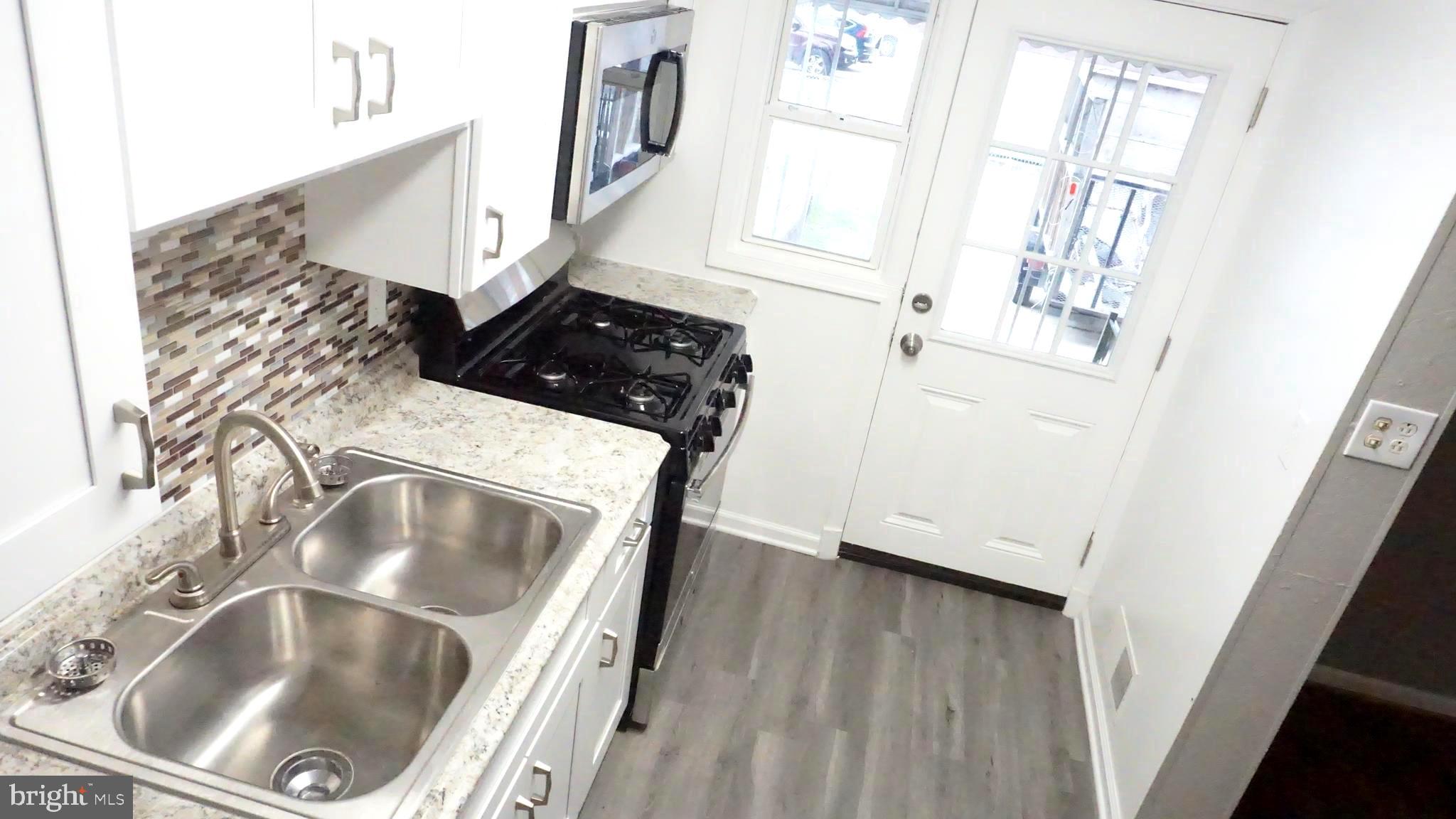 8155 Kavanagh Road Baltimore, MD 21222 - Photo 4 of 24 Double Bowl Sink and Gas Cooking. Walk out