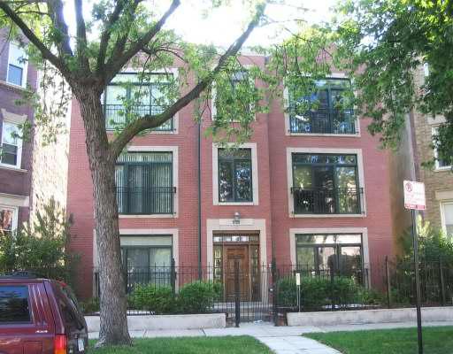 6120 South Ellis Avenue, Unit 3S Chicago, IL 60637 - Photo 1 of 1 a view of a brick house with a large windows and a large tree
