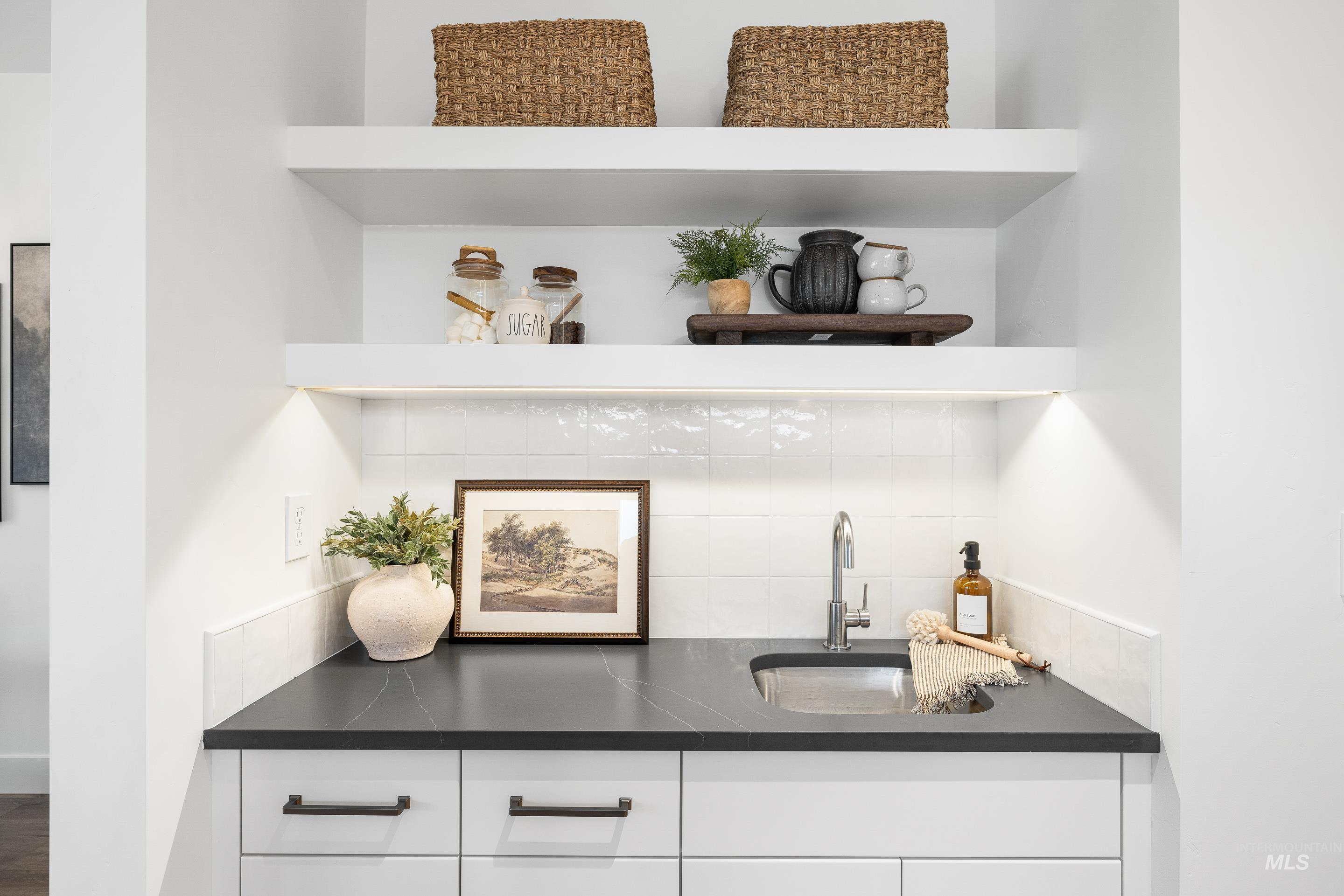 3071 North Lapis Avenue Meridian, ID 83646 - Photo 19 of 50 Bar featuring open shelves, white cabinetry, backsplash, and dark stone counters