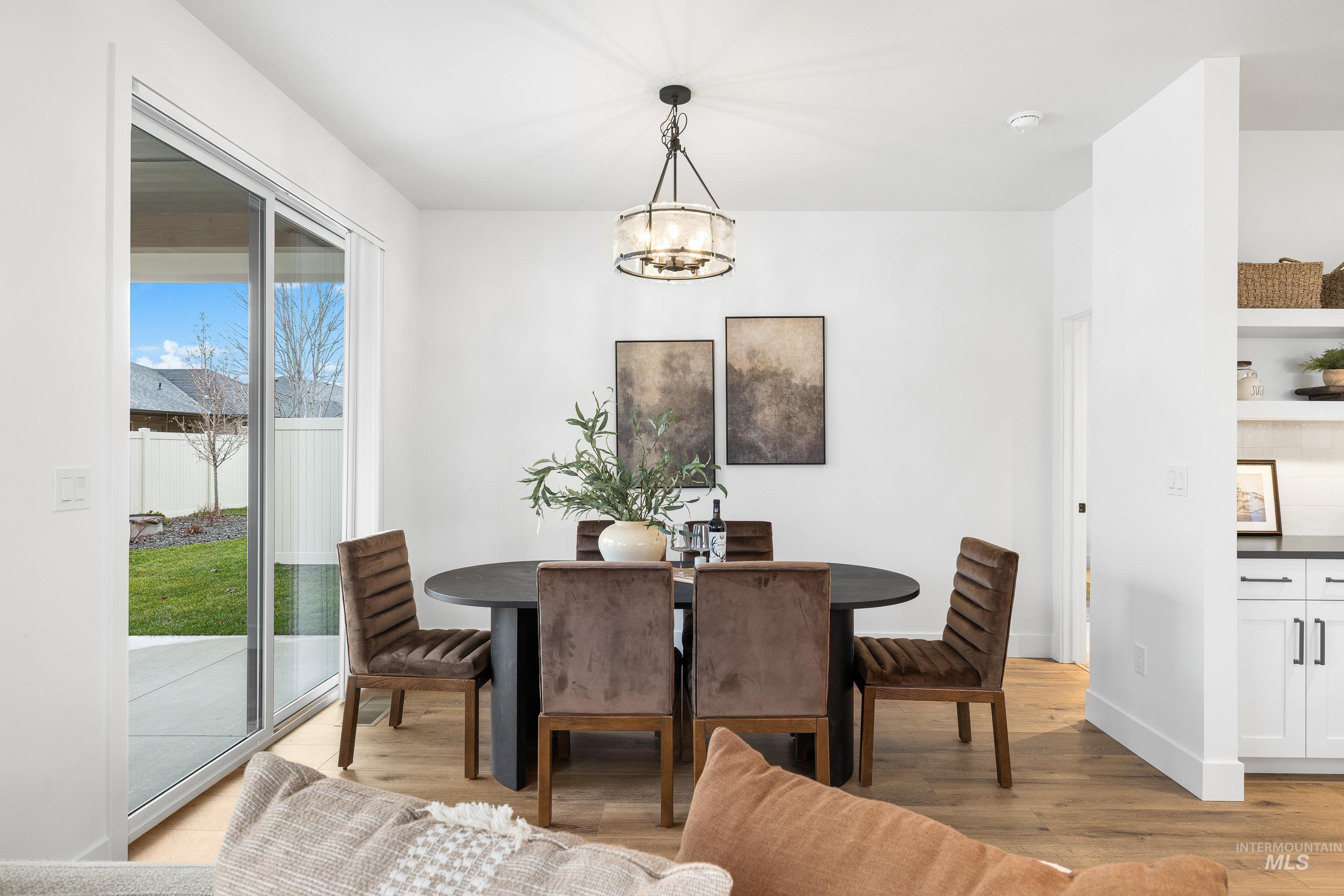 3071 North Lapis Avenue Meridian, ID 83646 - Photo 22 of 50 Dining space with light wood-type flooring and a chandelier