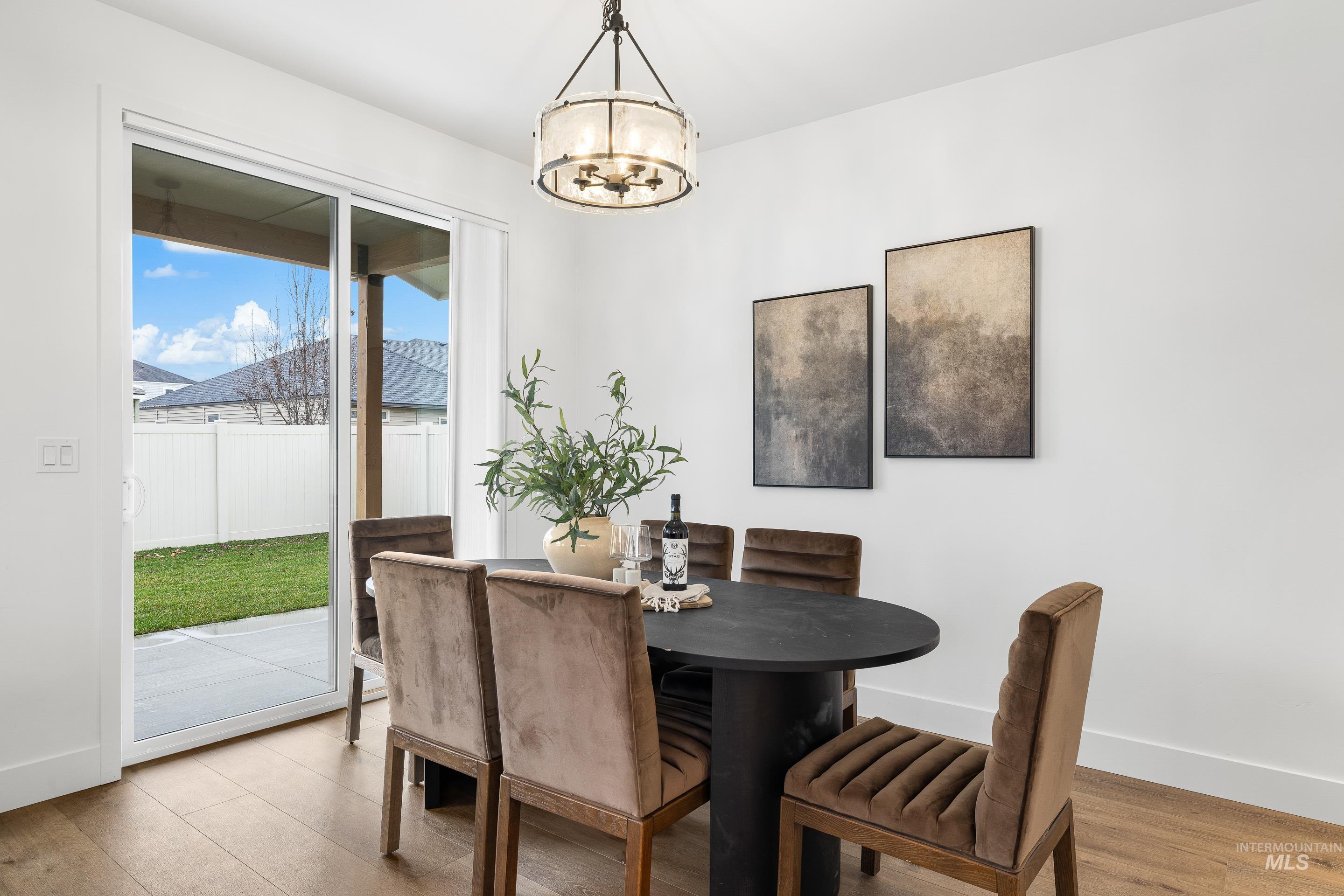 3071 North Lapis Avenue Meridian, ID 83646 - Photo 23 of 50 Dining area with wood finished floors and a chandelier