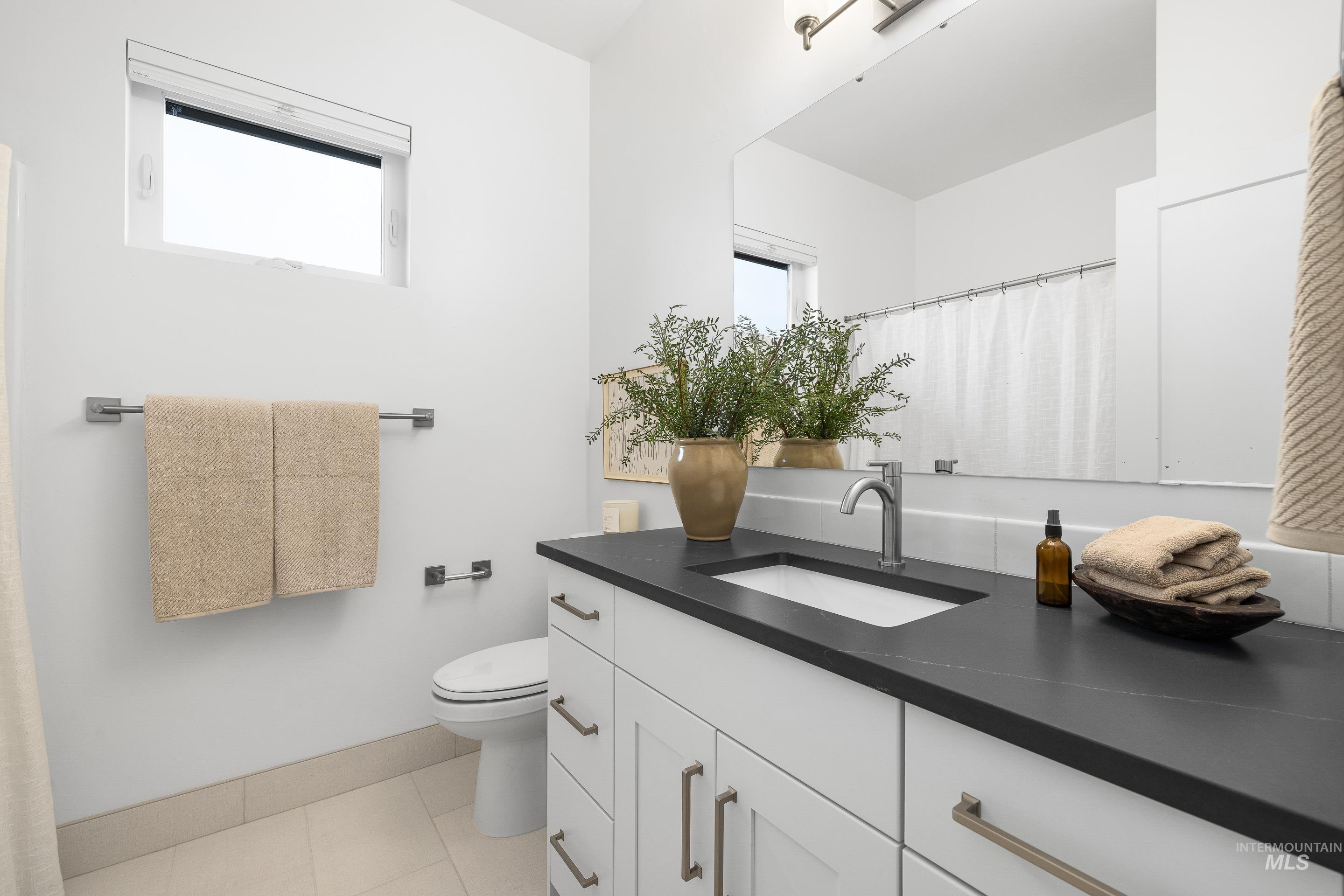 3071 North Lapis Avenue Meridian, ID 83646 - Photo 46 of 50 Bathroom with a shower with curtain, vanity, and light tile patterned flooring