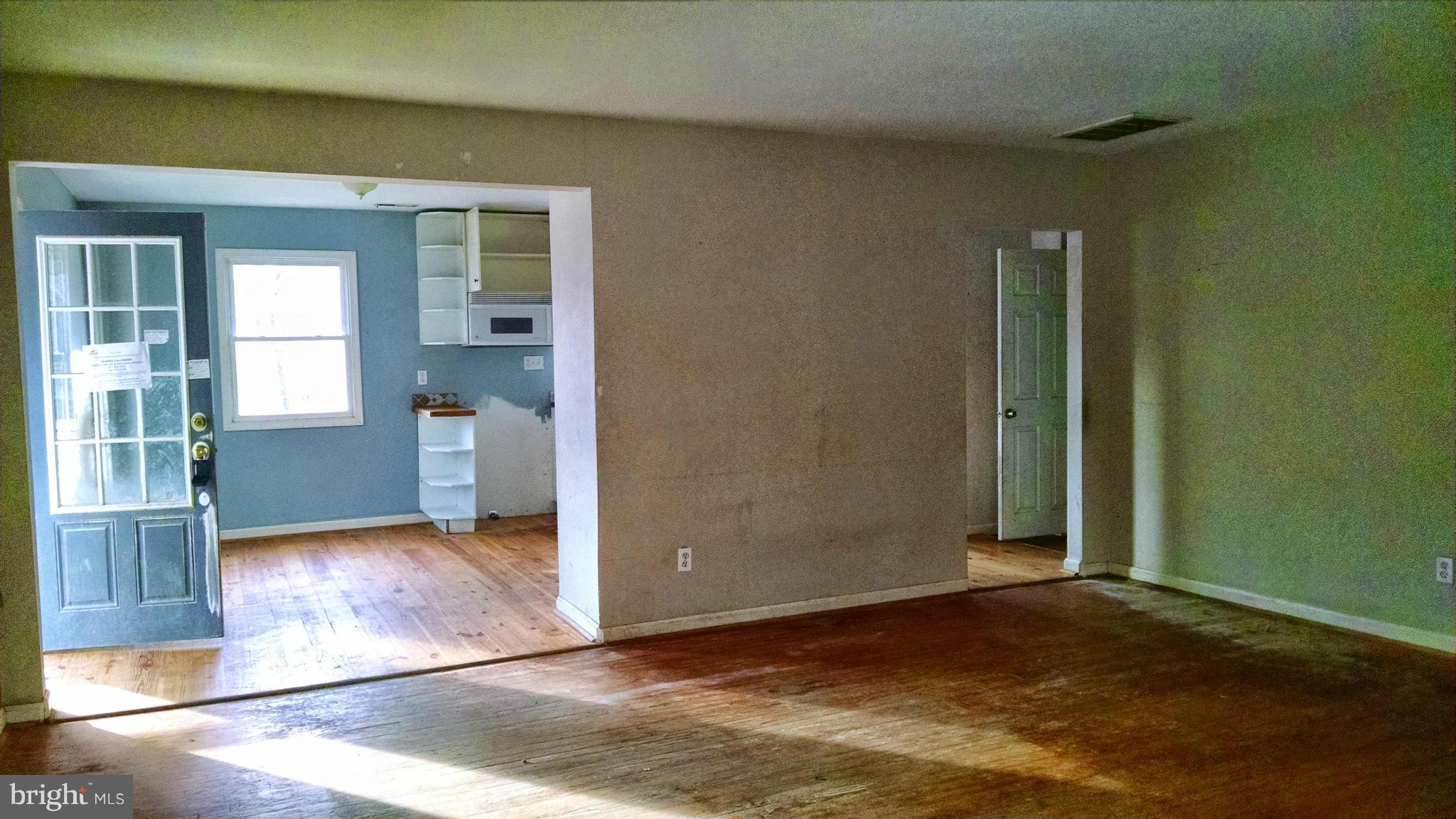 1249 Wrighton Road Lothian, MD 20711 - Photo 3 of 12 an empty room with wooden floor and windows