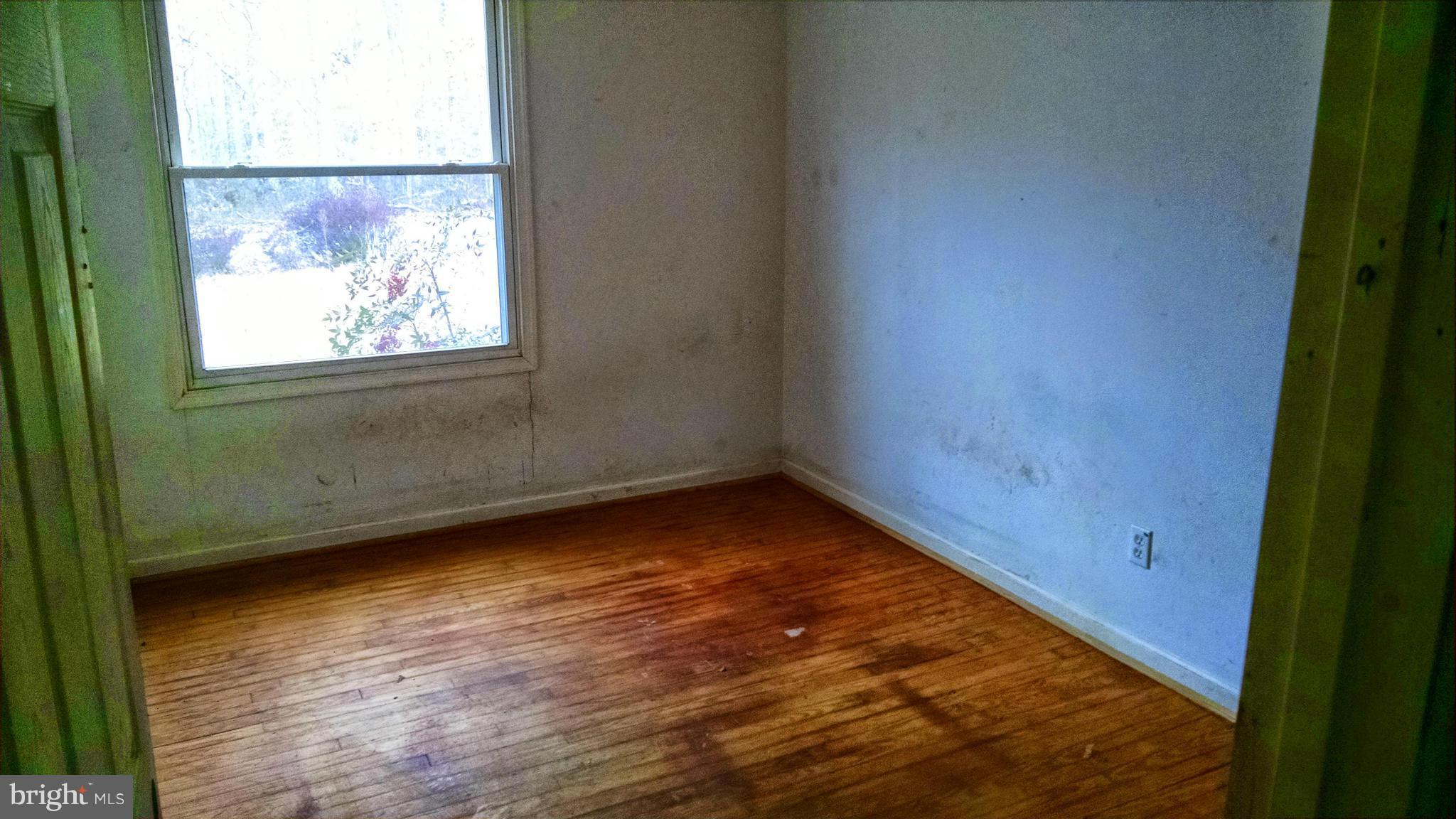 1249 Wrighton Road Lothian, MD 20711 - Photo 5 of 12 a view of a room with wooden floor and window