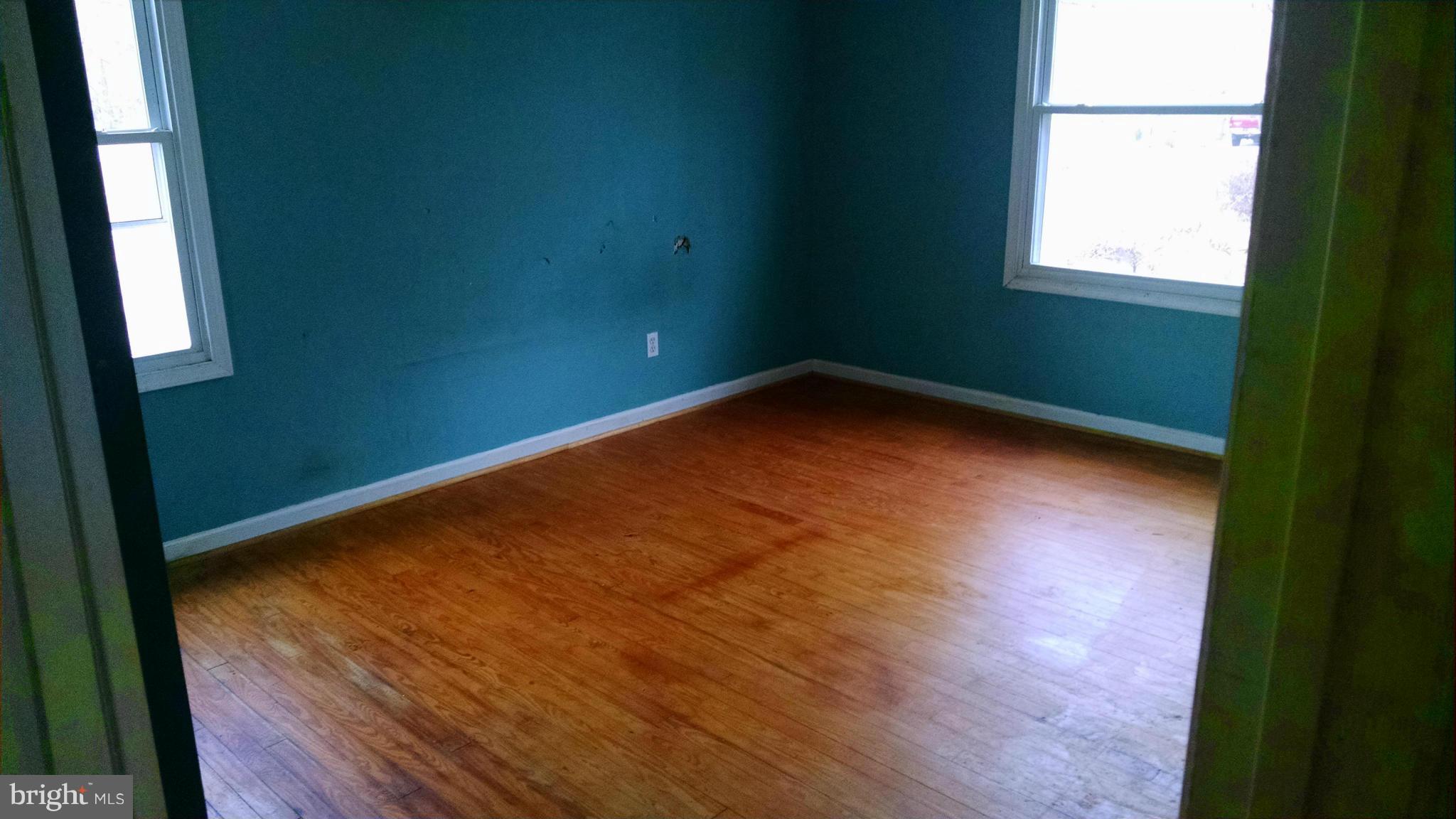 1249 Wrighton Road Lothian, MD 20711 - Photo 7 of 12 an empty room with wooden floor and windows