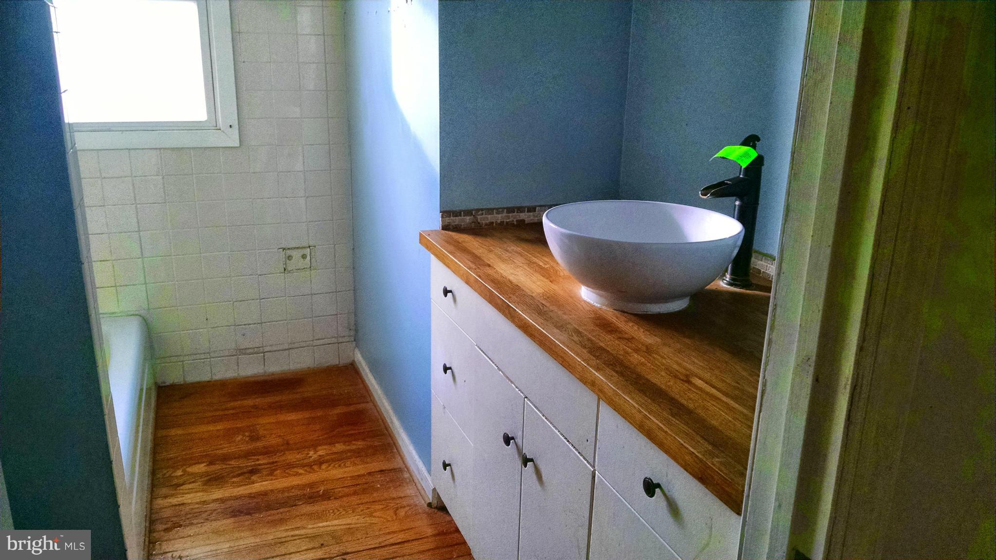 1249 Wrighton Road Lothian, MD 20711 - Photo 8 of 12 a bathroom with a granite countertop sink and toilet