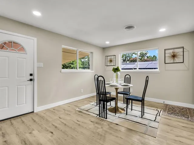 a view of a dining room with furniture and a window