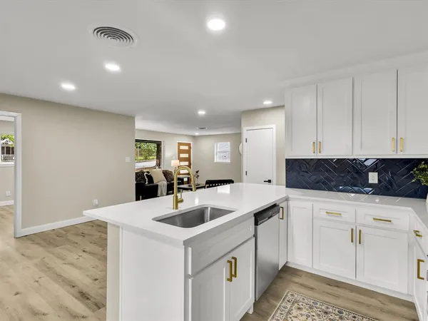 a kitchen with a sink and cabinets