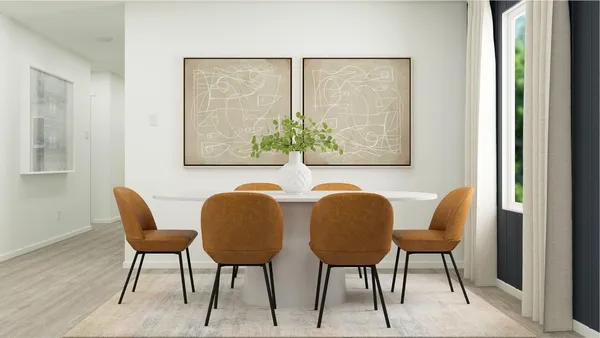 a view of a dining room with furniture and a potted plant