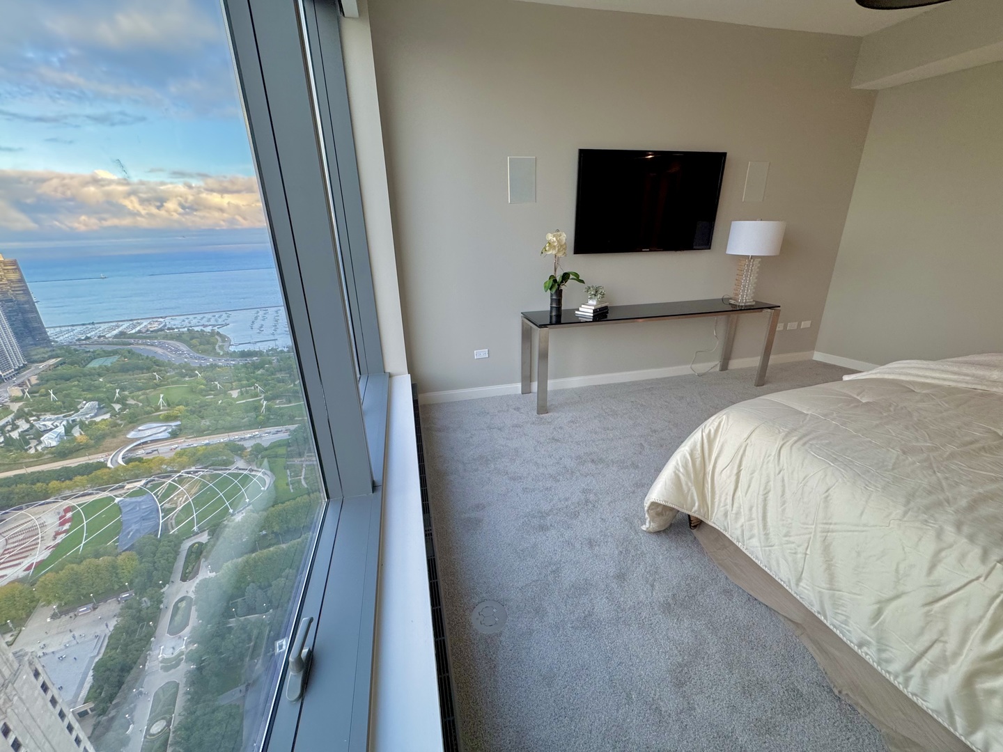 60 East Monroe Street, Unit 5601 Chicago, IL 60603 - Photo 15 of 50 a bed sitting in a bedroom next to a window