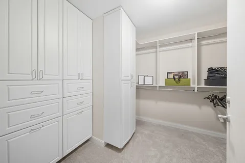 a en suite bathroom with a granite countertop sink and a mirror