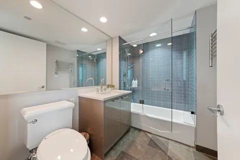 a bathroom with a toilet sink and shower