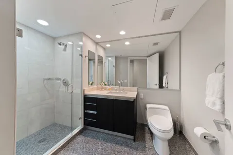 a bathroom with a toilet sink and shower