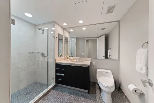 a bathroom with a toilet sink and shower