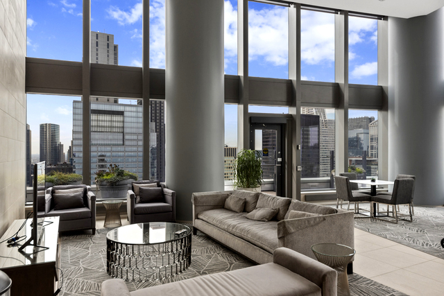 60 East Monroe Street, Unit 5601 Chicago, IL 60603 - Photo 39 of 50 a living room with furniture and a floor to ceiling window