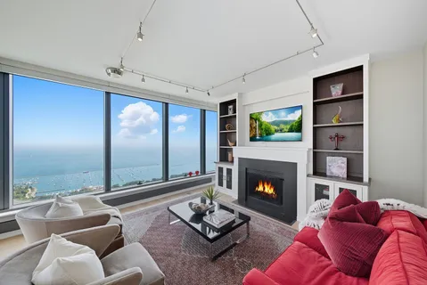 a living room with furniture fireplace and rug