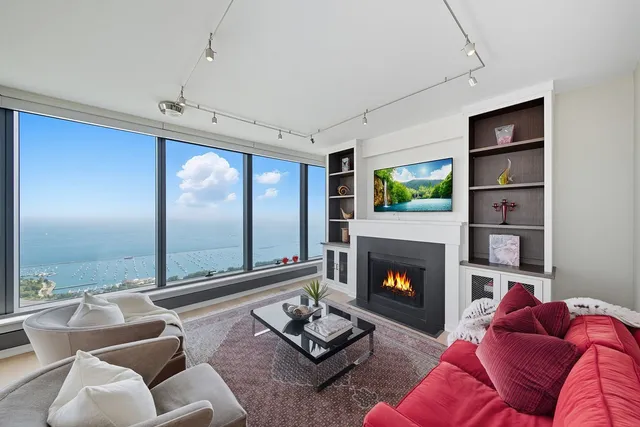 a living room with furniture fireplace and rug