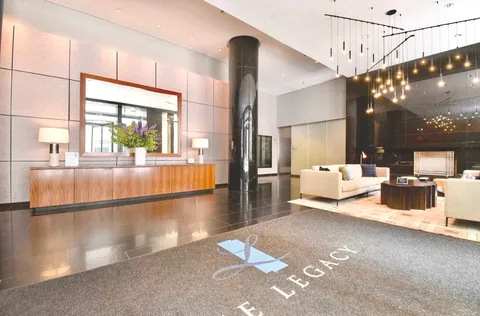 a kitchen with lots of clutter and stainless steel appliances