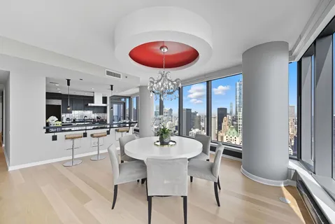 a dining room with furniture and wooden floor