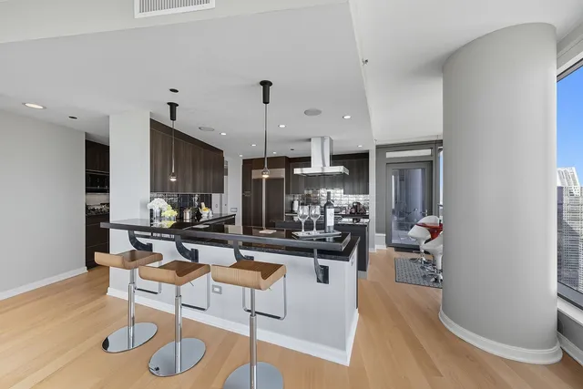a living room with furniture a dining table and kitchen view