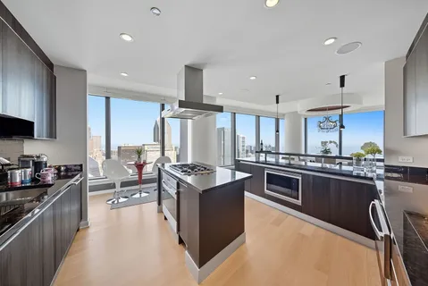 a large kitchen with stainless steel appliances lots of counter top space