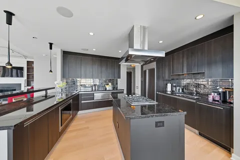 a kitchen with stainless steel appliances granite countertop a sink and stove