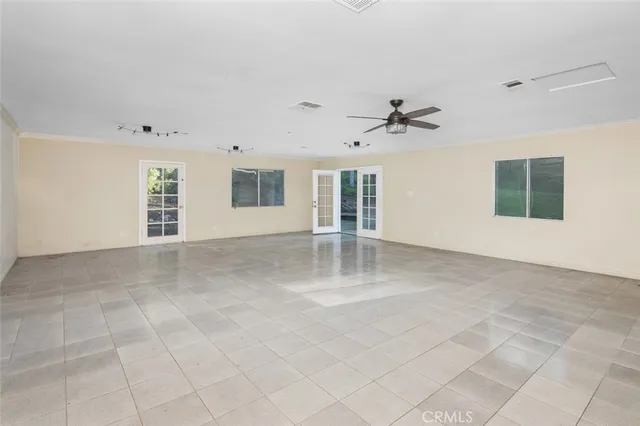 a living room with furniture a rug and a bookshelf
