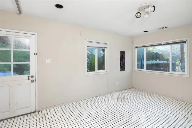 a bathroom with a granite countertop toilet sink and mirror