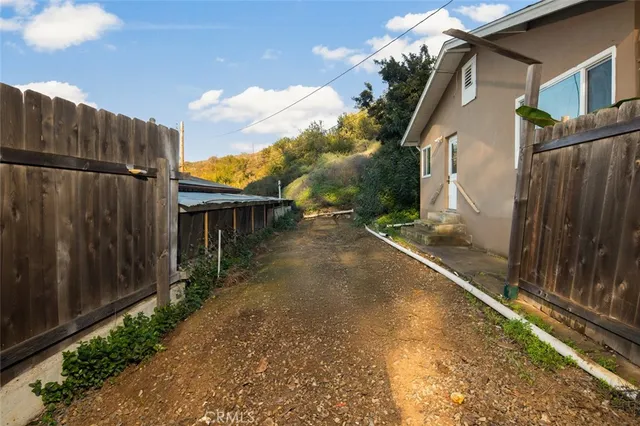 an aerial view of a house with yard and trees