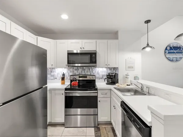 a kitchen with stainless steel appliances a sink and a refrigerator