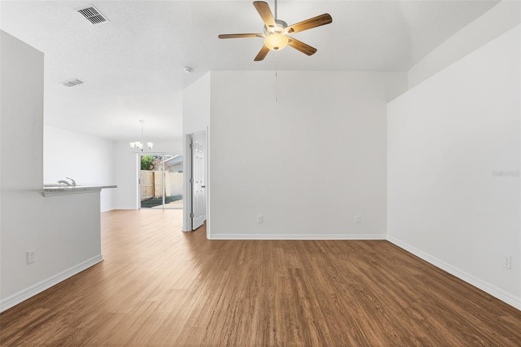 914 Stallion Way Valrico, FL 33594 - Photo 18 of 38 a view of empty room with wooden floor and fan