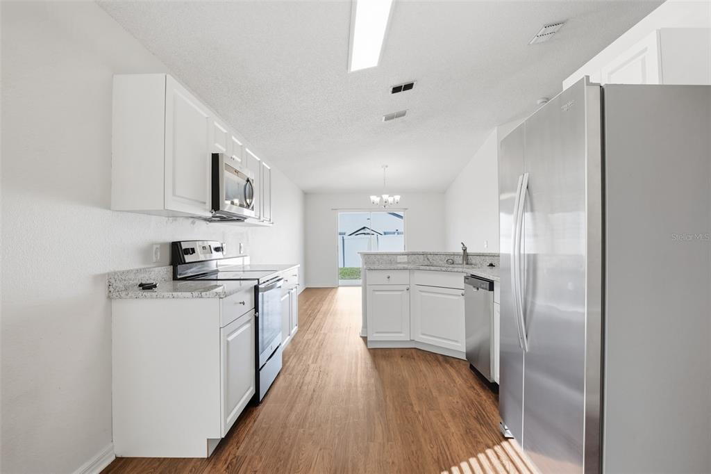 914 Stallion Way Valrico, FL 33594 - Photo 21 of 38 a kitchen with a sink cabinets stainless steel appliances and a window