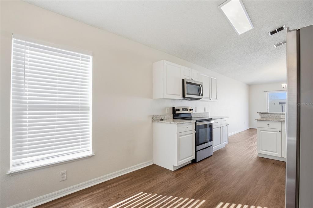 914 Stallion Way Valrico, FL 33594 - Photo 23 of 38 a kitchen with a refrigerator and a stove top oven