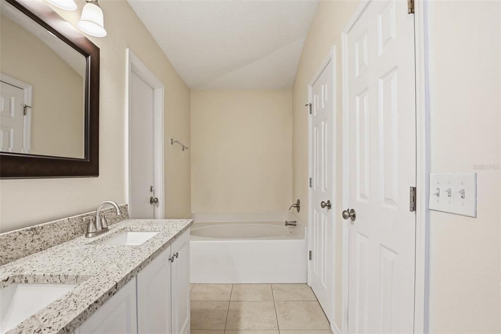 914 Stallion Way Valrico, FL 33594 - Photo 31 of 38 a bathroom with a granite countertop sink and a mirror