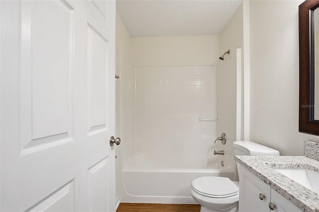 914 Stallion Way Valrico, FL 33594 - Photo 33 of 38 a bathroom with a granite countertop bathtub shower sink vanity and toilet