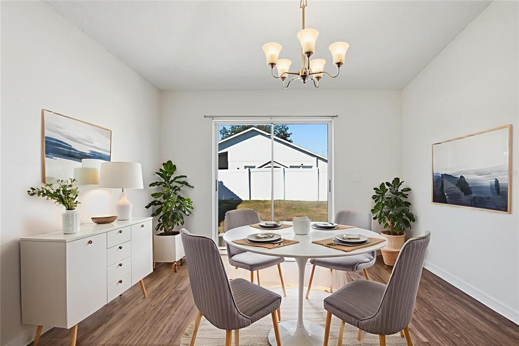 914 Stallion Way Valrico, FL 33594 - Photo 4 of 38 a view of a dining room with furniture and wooden floor