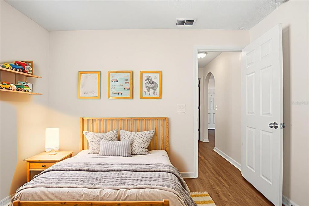 914 Stallion Way Valrico, FL 33594 - Photo 6 of 38 a bedroom with a bed and wooden floor