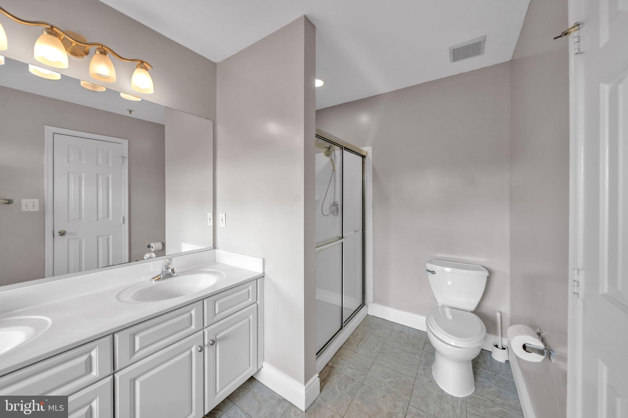 122 Longpoint Way Gaithersburg, MD 20878 - Photo 12 of 37 a bathroom with a toilet sink and mirror