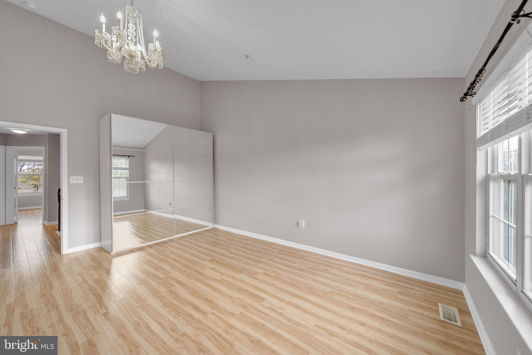 122 Longpoint Way Gaithersburg, MD 20878 - Photo 20 of 37 a view of an empty room with wooden floor and a window