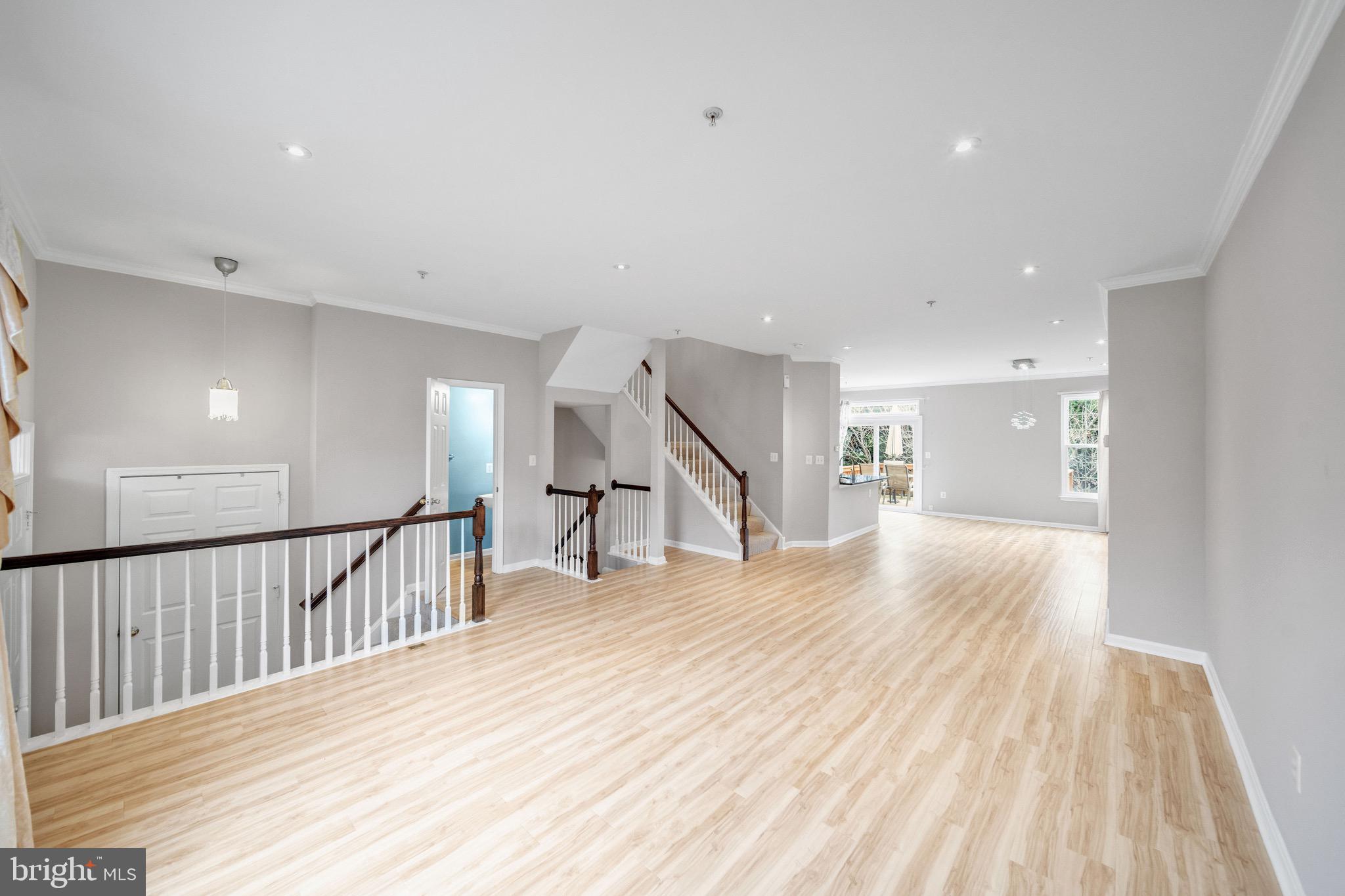 122 Longpoint Way Gaithersburg, MD 20878 - Photo 2 of 37 a view of a hallway with wooden floor and staircase
