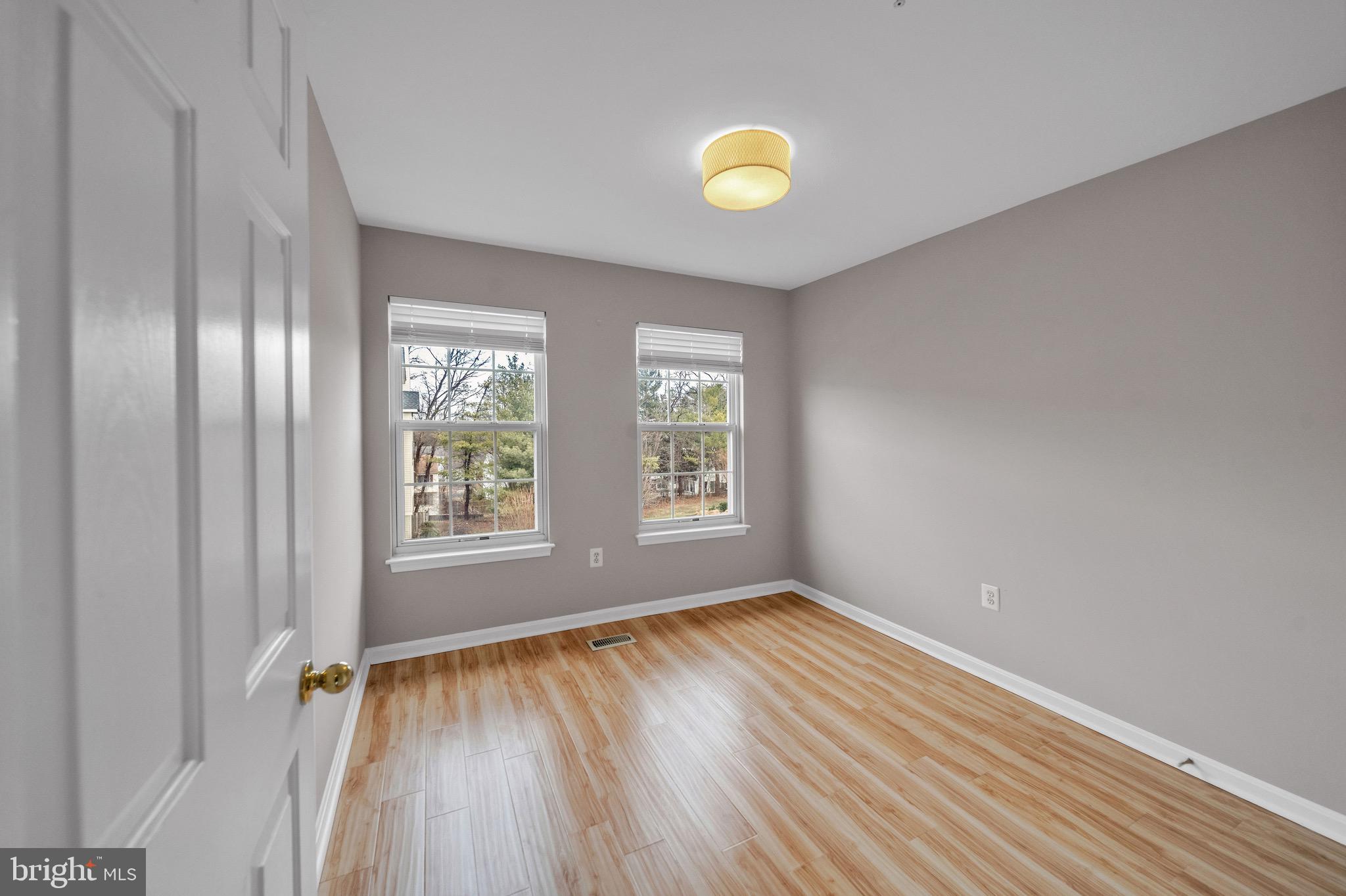 122 Longpoint Way Gaithersburg, MD 20878 - Photo 22 of 37 wooden floor in an empty room with a window